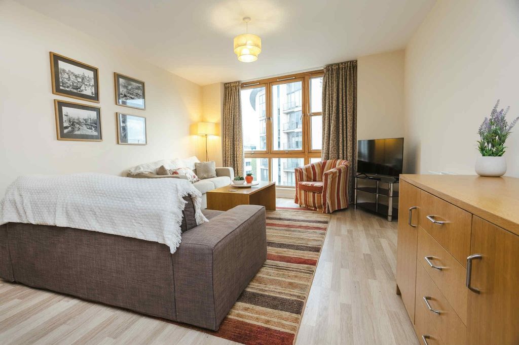 Property photo 3 of 28 Bright And Welcoming Living Room Featuring Large W...