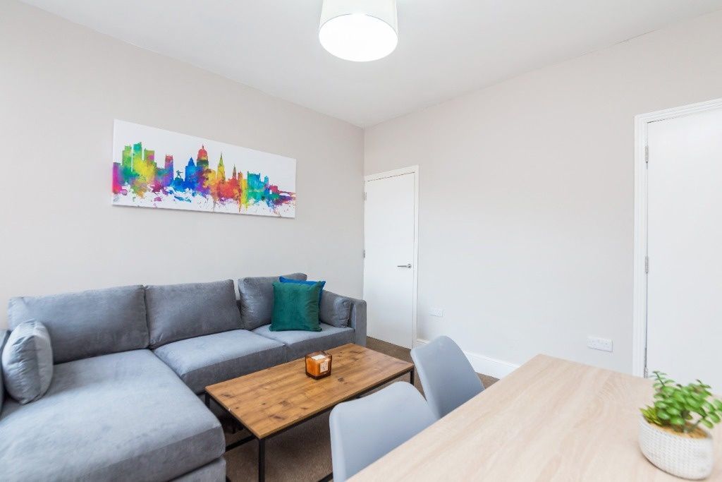 Property photo 2 of 11 A Modern And Tidy Living Room Featuring A Comforta...