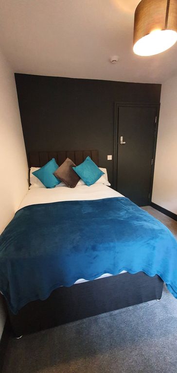 Property photo 3 of 6 Cozy Double Bedroom Featuring A Comfortable Bed Ad...
