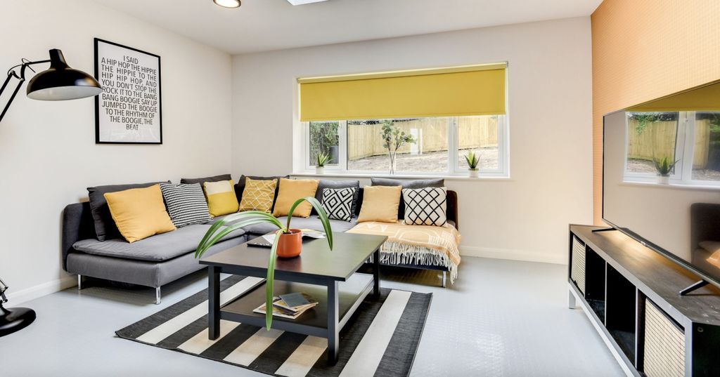 Property photo 2 of 6 A Modern And Inviting Living Room Featuring A Cozy...