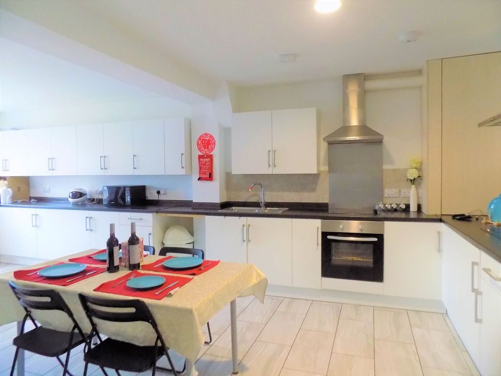 Property photo 3 of 32 Bright And Modern Kitchen Featuring Ample White Ca...