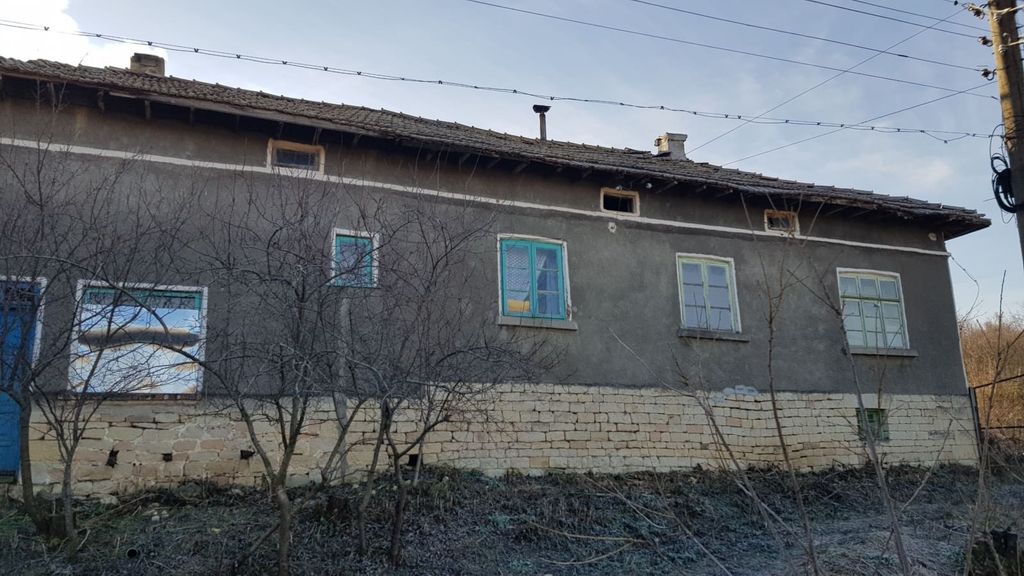 Property photo 1 of 39 Front Side Of A Bulgarian Village House Showing Stone Foundation And Plastered Walls With Multiple Windows
