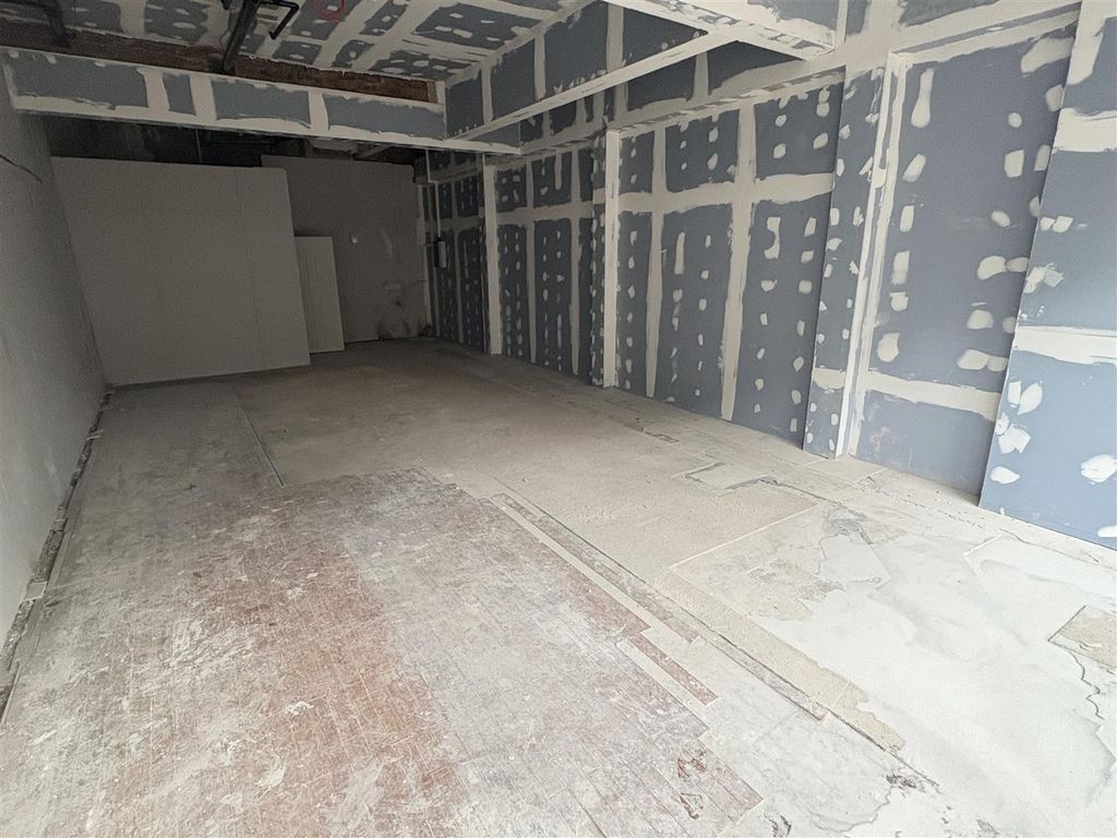 Property photo 3 of 4 Long Empty Interior With High Ceilings And Natural...