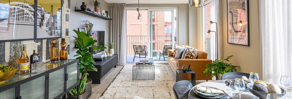 Property photo 1 of 8 Living Space With Sofa And Coffee Table Adjacent To Balcony Doors, Dining Table And Shelving In
