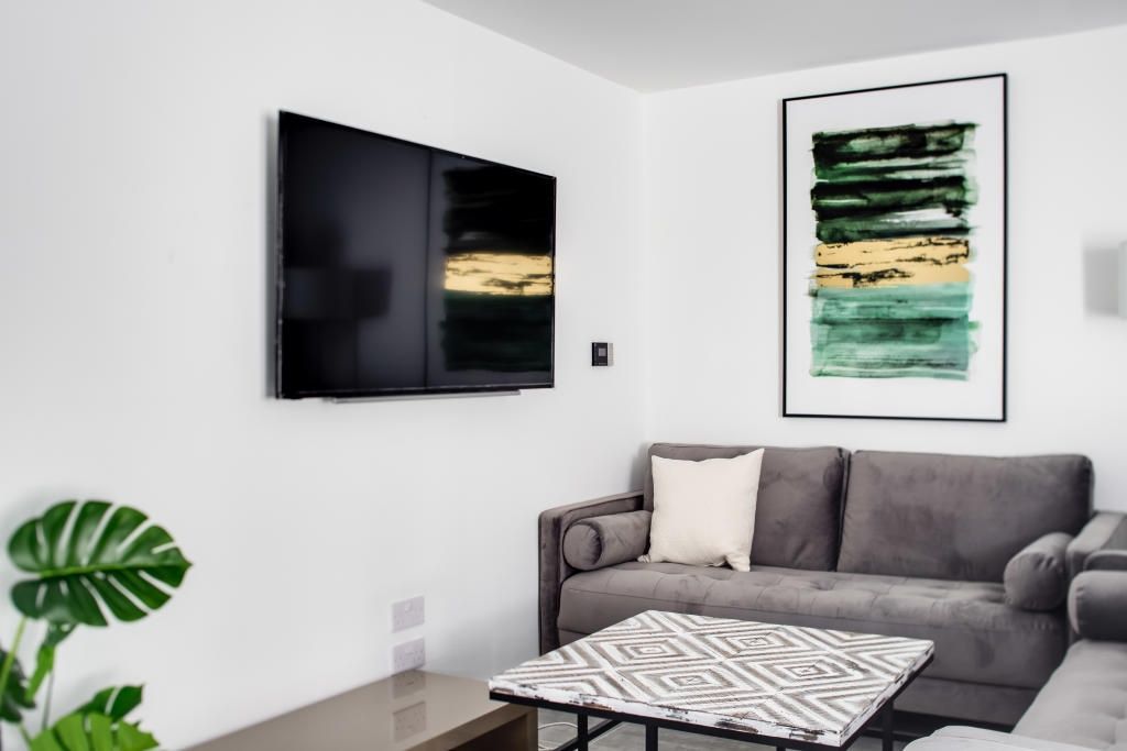 Property photo 3 of 13 A Modern, Well-Lit Living Room Featuring A Comfort...