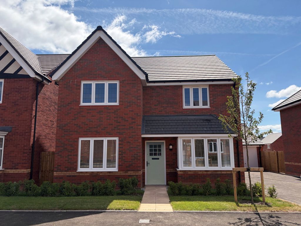 Property photo 1 of 10 A Modern Red Brick House With White-Framed Windows And A Light Green Door Stands On A Paved Driveway