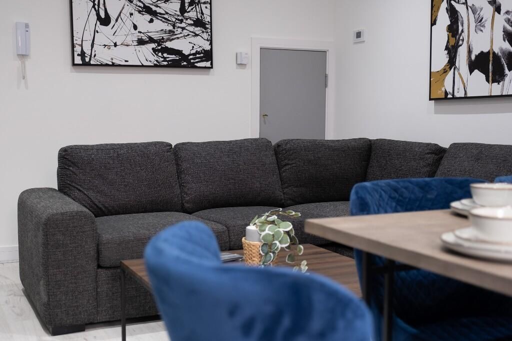 Property photo 1 of 11 A Modern Living Room Featuring A Large Dark Gray S...