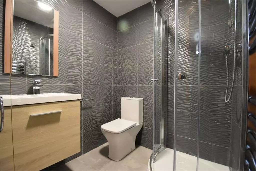 Property photo 1 of 11 Modern Bathroom Featuring Textured Grey Tiles, A G...