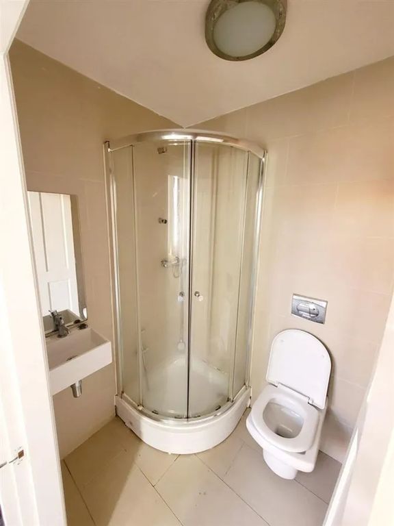 Property photo 2 of 10 A Neat And Modern Bathroom Featuring A Curved Glas...