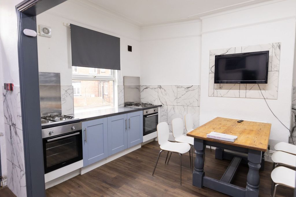 Property photo 2 of 12 Bright And Modern Kitchen With Blue Cabinetry, A l...