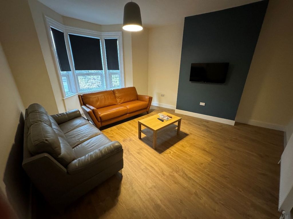 Property photo 2 of 15 A Stylish And Inviting Living Room Featuring A Com...