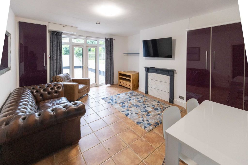 Property photo 1 of 5 Bright And Spacious Living Room Featuring Comforta...