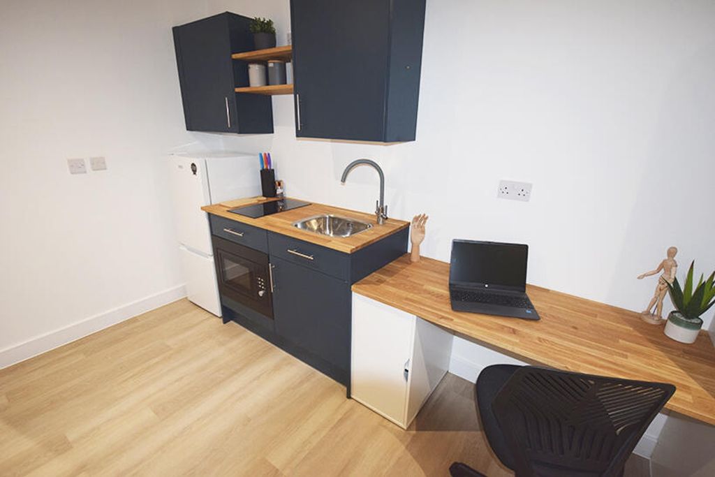 Property photo 3 of 4 This Stylish Kitchenette Features Modern Cabinetry...