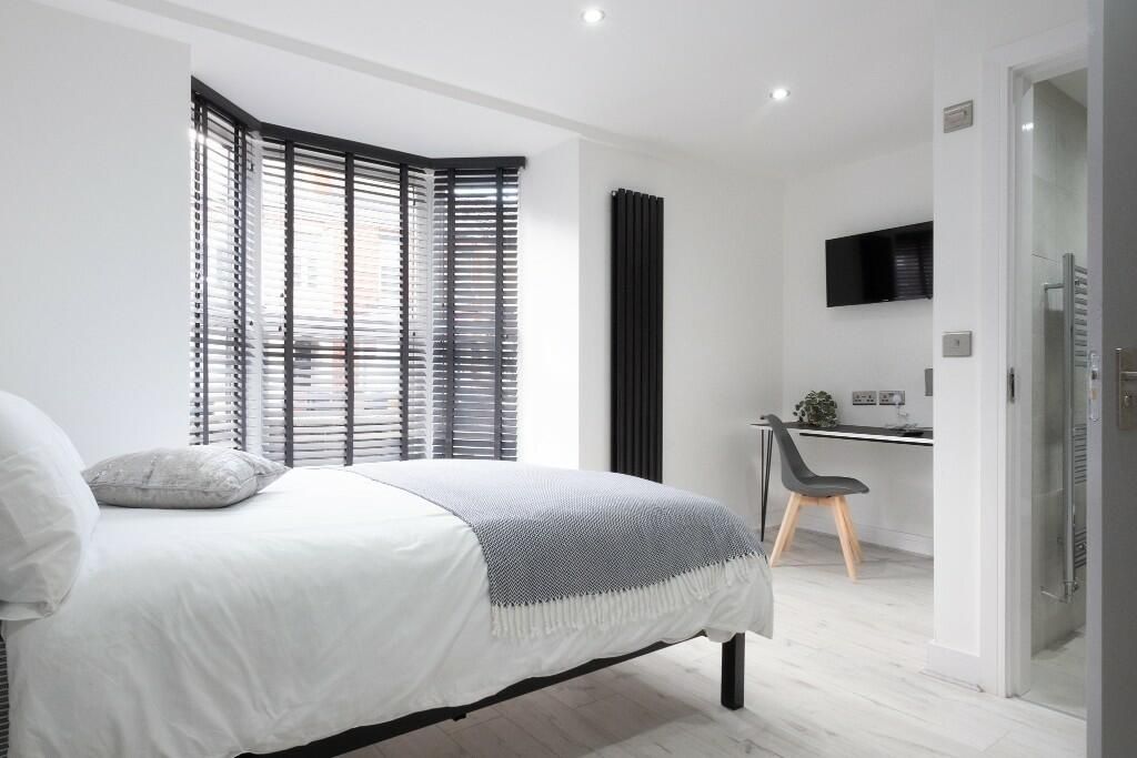 Property photo 1 of 14 Bright And Modern Master Bedroom Featuring A Comfo...