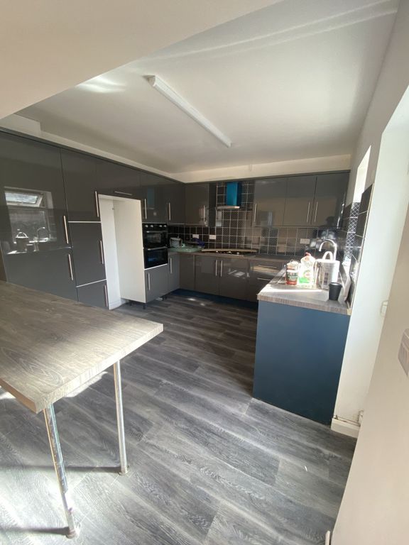 Property photo 2 of 6 Modern Kitchen Featuring Sleek Grey Cabinetry With...