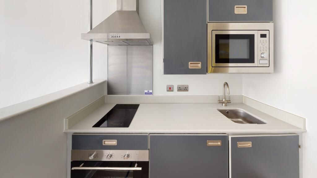 Property photo 1 of 4 Modern Kitchen Featuring Sleek Grey Cabinetry, Int...