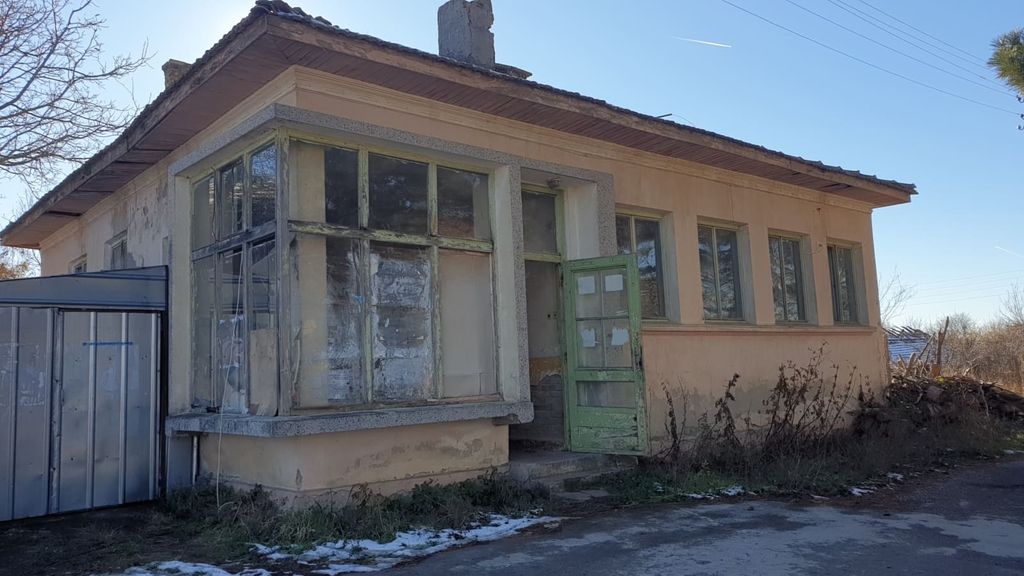 Property photo 2 of 35 Side Perspective Of The Old Bakery Showing Beige Walls, Green Door, And Adjacent Metal Shed Under A Clear Sky.