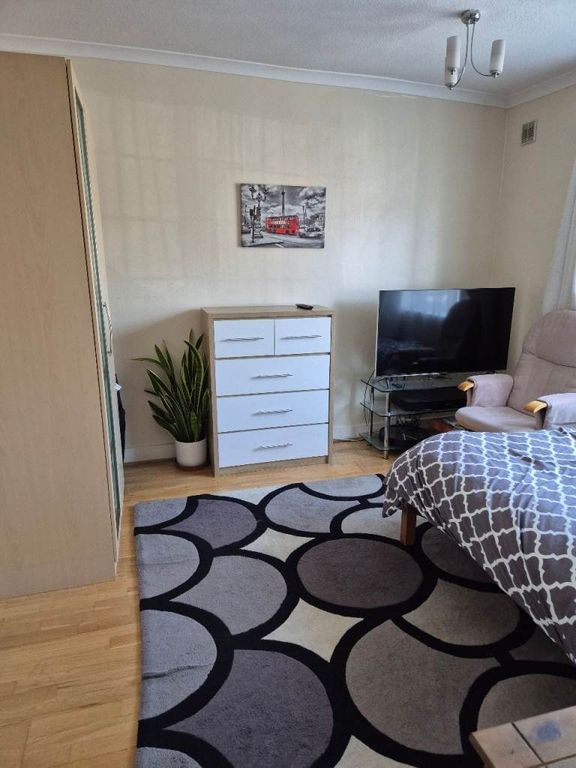 Property photo 3 of 4 Bright Bedroom With Stylish Rug And Ample Storage...