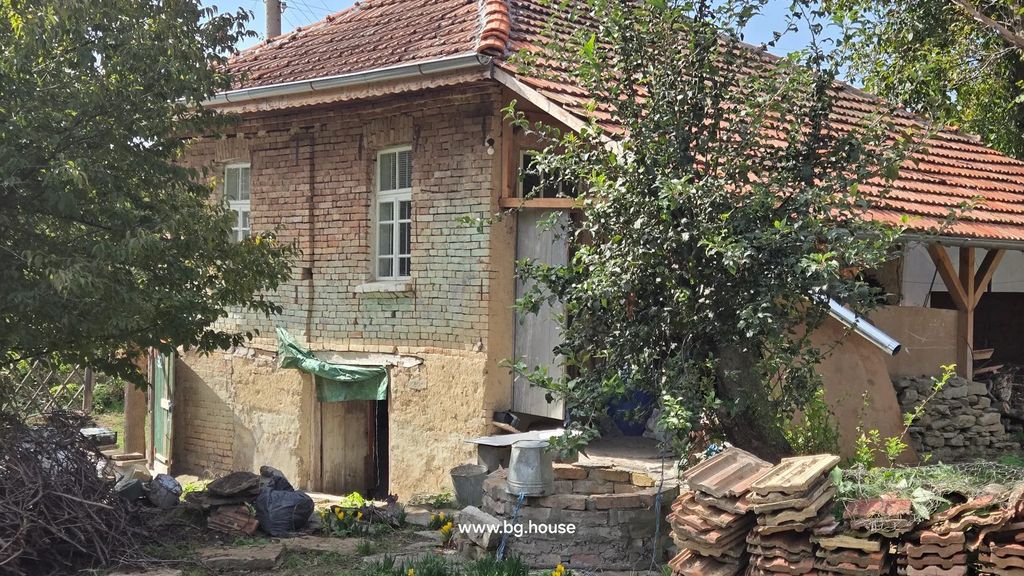 Property photo 3 of 40 Close-Up View Of Brick House With Tiled Roof, Trees, And Stacked Roof Tiles In The Garden