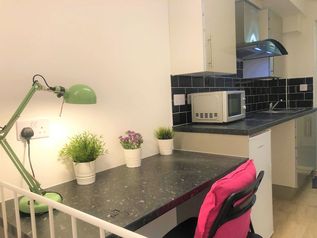 Property photo 2 of 9 Bright And Tidy Kitchen Space Featuring A Sleek Bl...
