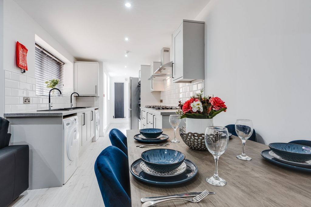 Property photo 3 of 12 Modern And Well-Maintained Kitchen Featuring White...