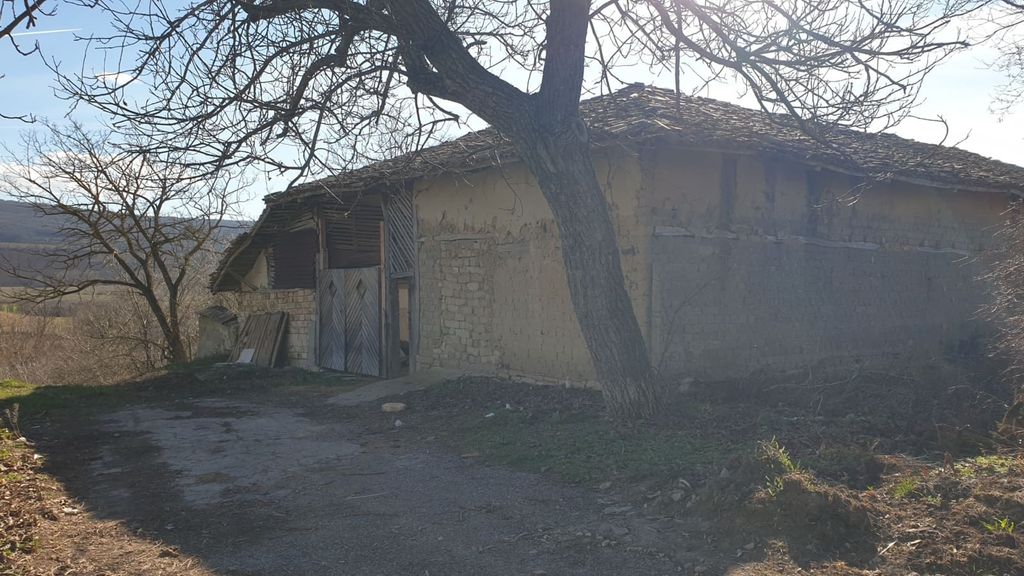 Property photo 2 of 100 View Of A Large Rustic Outbuilding Featuring Wooden Doors And Mud Brick Walls, Surrounded By Bare Trees