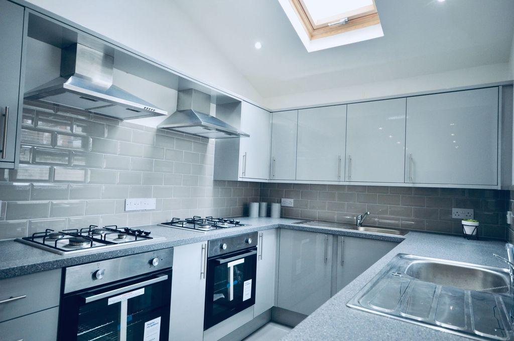 Property photo 3 of 9 Modern And Well-Maintained Kitchen Featuring Sleek...