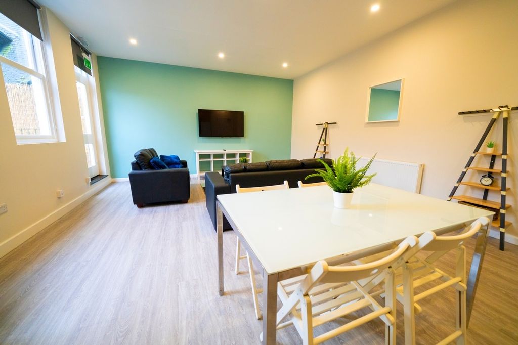 Property photo 2 of 6 Bright And Modern Living Room Featuring A Comforta...