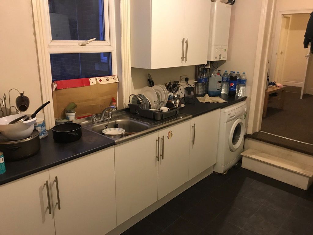 Property photo 2 of 4 A Functional Kitchen With A Black Countertop, Whit...