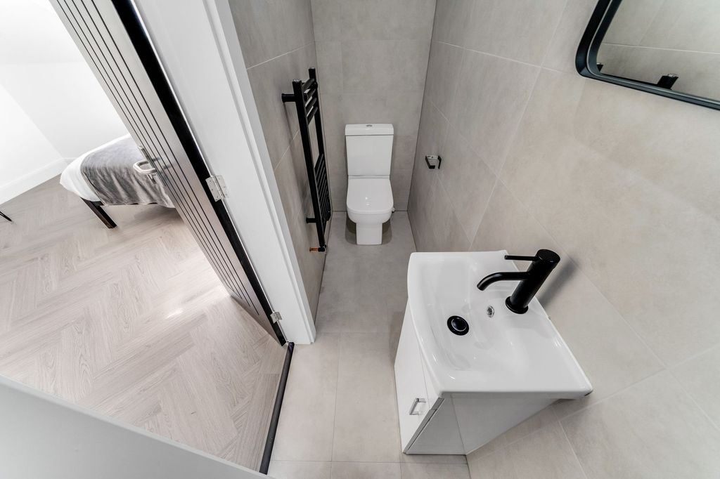 Property photo 3 of 4 Modern And Clean Bathroom Featuring A White Toilet...