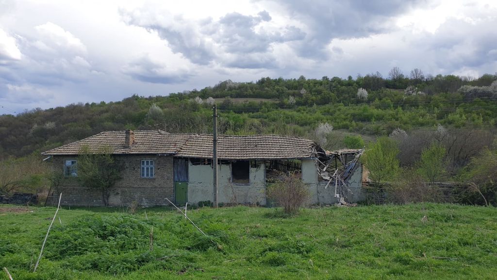 Property photo 2 of 41 Side Perspective Of An Old House Showing A Partially Collapsed Roof And Green Field With Hills In The Background.