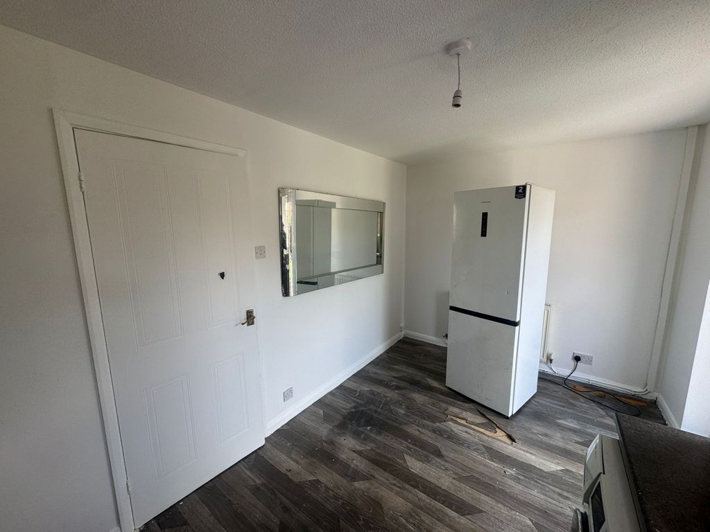Property photo 1 of 9 A Clean, Modern Kitchen Space Featuring Wood-Effec...