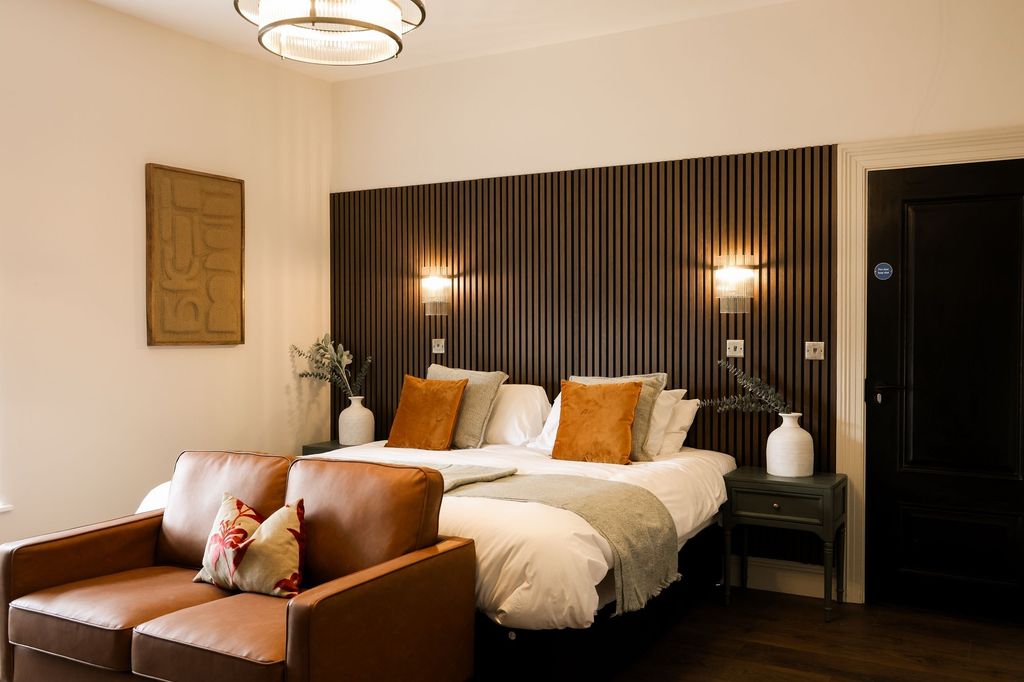 Property photo 1 of 11 Elegant Bedroom With Wood Paneling And Leather Sof...