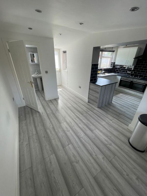 Property photo 3 of 12 Bright And Modern Kitchen Space Featuring Sleek Gr...