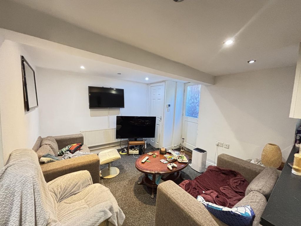 Property photo 1 of 20 A Spacious And Modern Living Room Featuring Comfor...