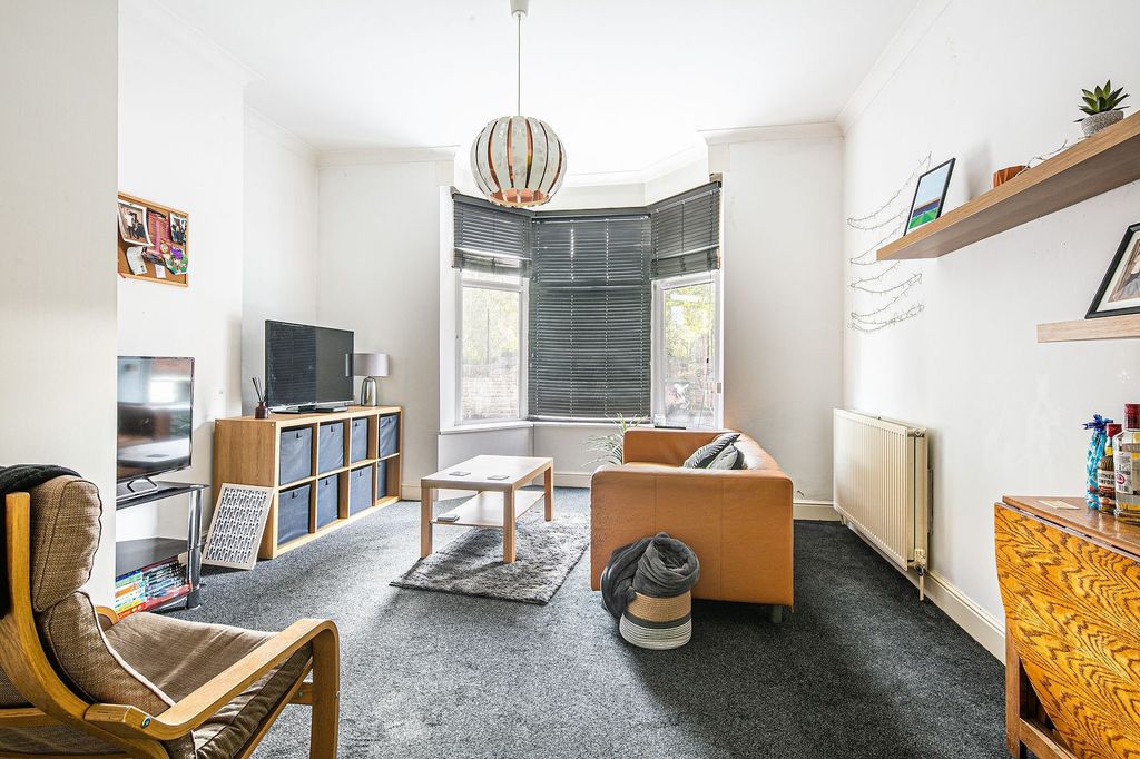 Property photo 2 of 5 A Bright And Inviting Living Room Featuring A Comf...