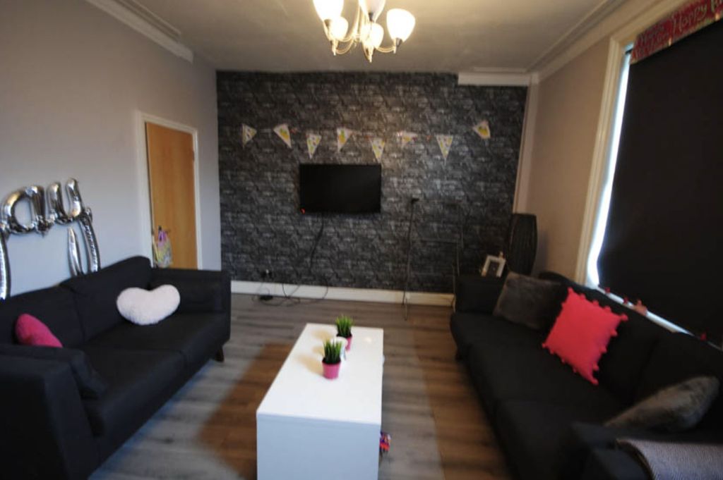 Property photo 3 of 21 Modern And Cozy Living Room Featuring A Black Sofa...