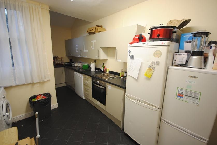 Property photo 3 of 10 Long Galley-Style Kitchen With Integrated Oven And...