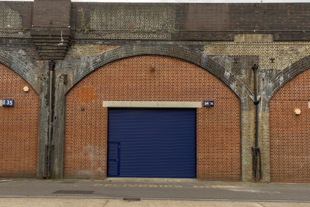 Property photo 3 of 5 The Front Of An Arch With A Closed Electric Roller Shutter Entrance Big Enough For Vehicle Access.