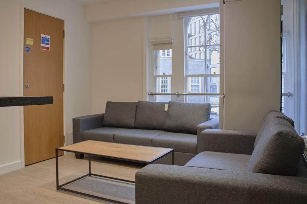 Property photo 2 of 10 A Spacious And Modern Living Room Featuring Comfor...