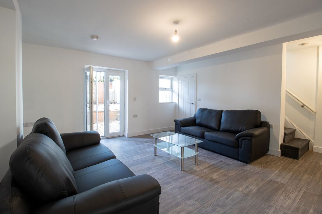 Property photo 2 of 13 A Modern, Well-Lit Living Room Featuring Comfortab...