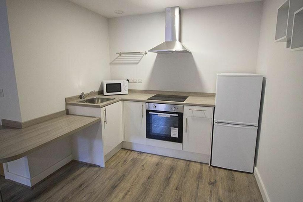 Property photo 3 of 4 Modern Kitchen Featuring Sleek Cabinetry And Effic...