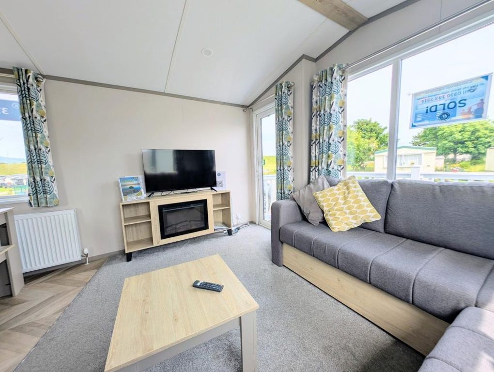 Property photo 3 of 10 Bright Lounge With L Shaped Seating, Electric Fire And Patio Doors