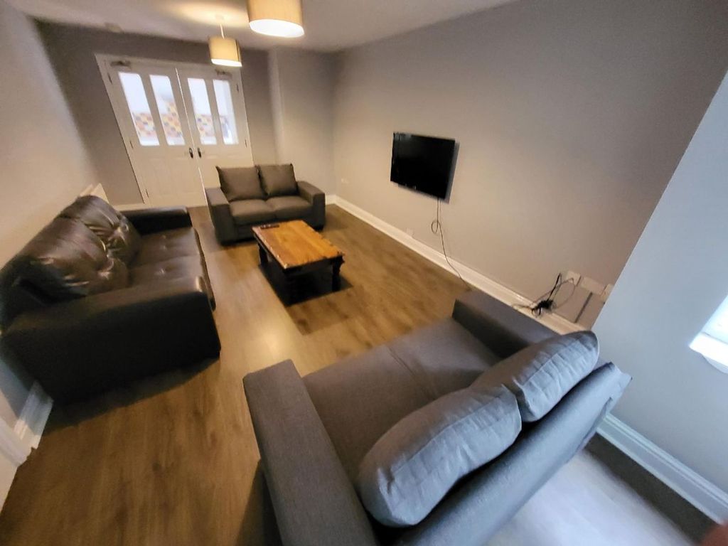 Property photo 3 of 12 Spacious And Inviting Living Room Featuring Comfor...