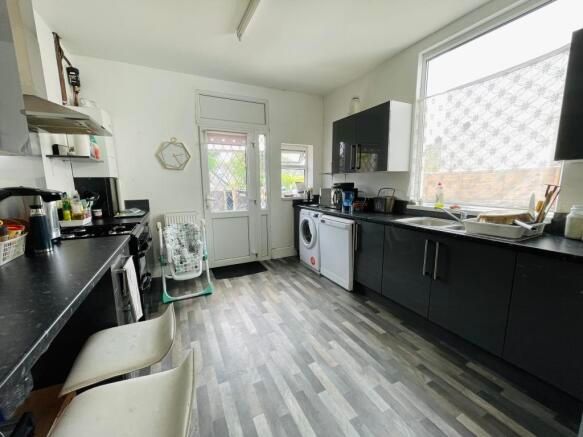 Property photo 2 of 12 Bright, Modern Kitchen With Ample Dark Cabinetry, ...