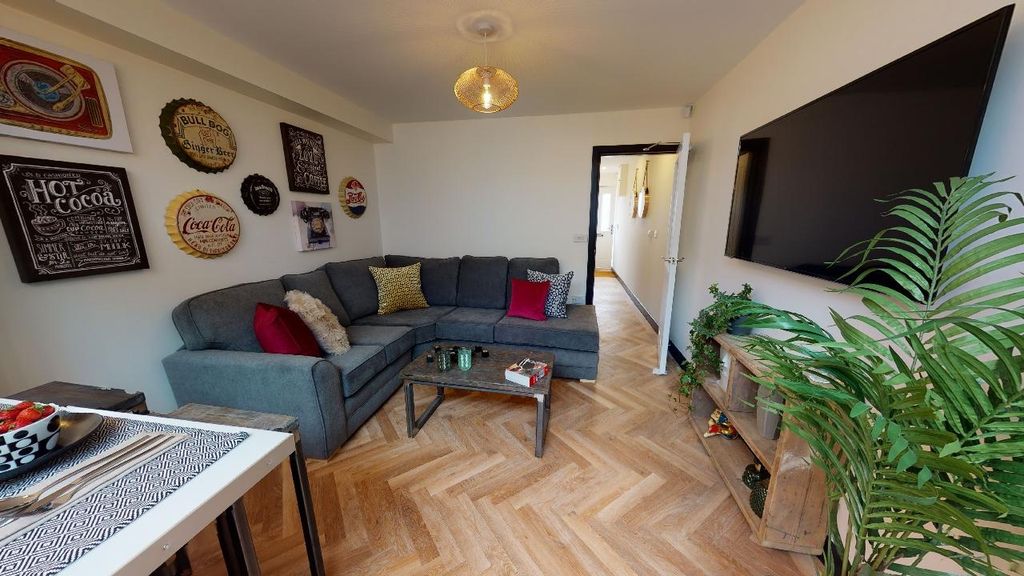 Property photo 3 of 7 A Spacious, Well-Lit Living Room Featuring A Large...