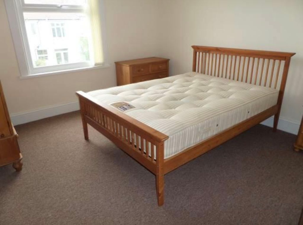 Property photo 3 of 7 Bright, Simply Furnished Bedroom With A Wooden Dou...