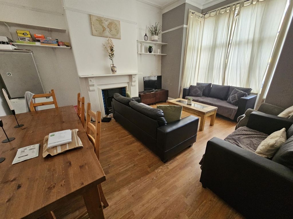 Property photo 2 of 28 A Welcoming And Well-Lit Living Room With Ample Sp...