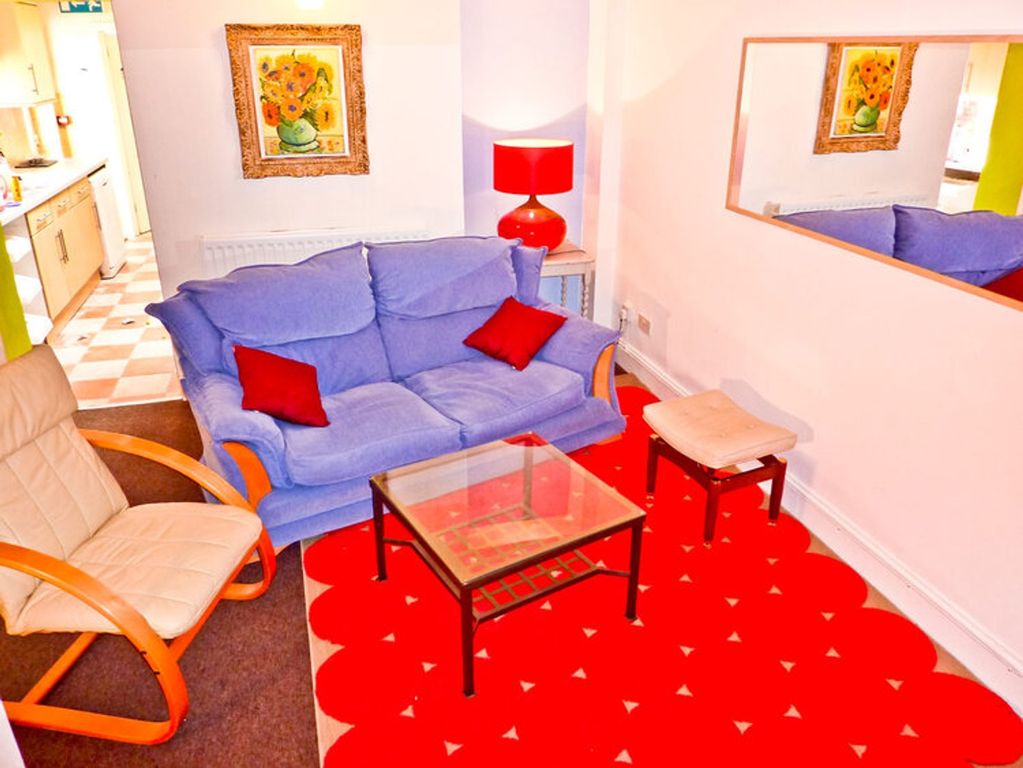 Property photo 3 of 6 A Cozy And Inviting Living Room Featuring Comforta...