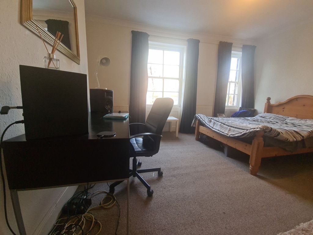 Property photo 1 of 19 A Bright And Inviting Bedroom Featuring A Wooden B...